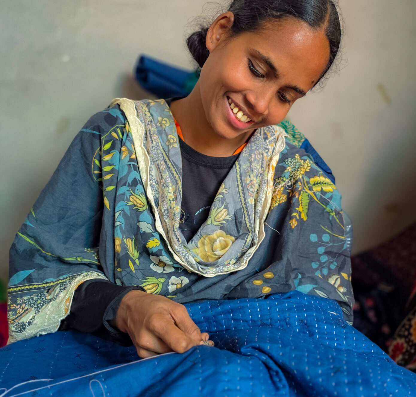 Maya’s Gratitude Maya sews happily reflecting on her winning life.